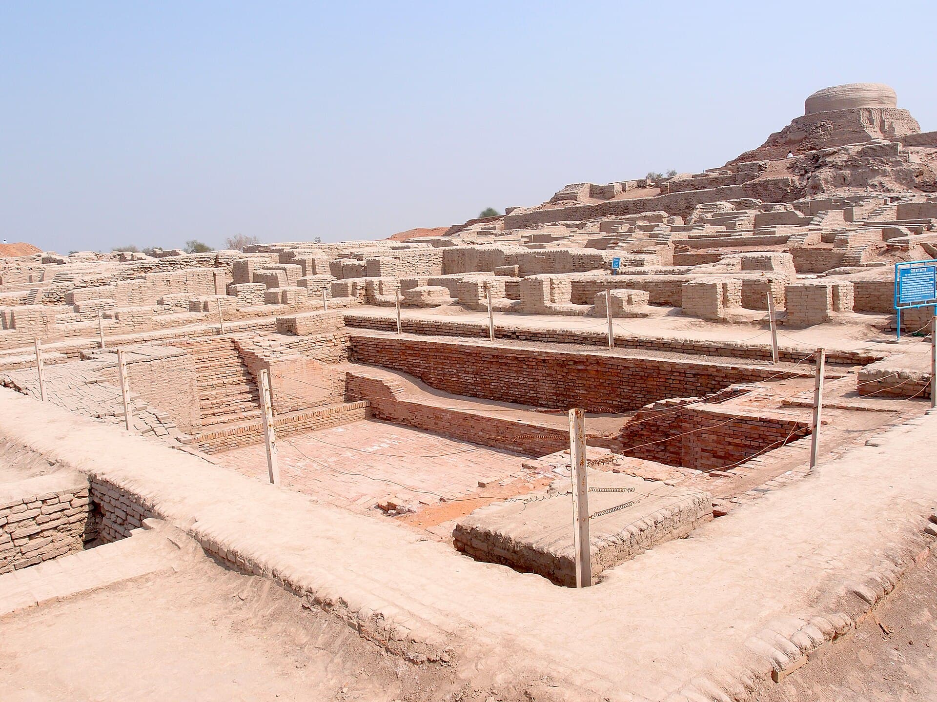 Brick ruins of the ancient city of Mohenjo-daro under a clear sky