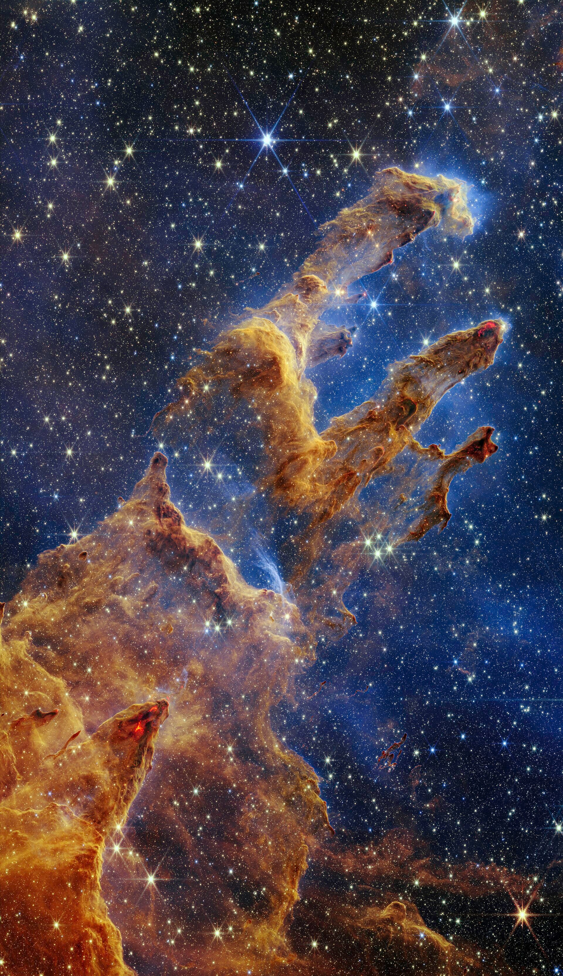 The Pillars of Creation: three tall columns of interstellar gas and dust lit by newborn stars